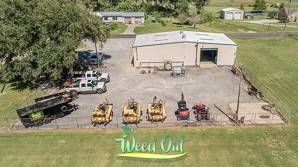 Weed-Out crew operating environmental workboat equipment beside a waterway